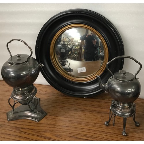 332 - A Regency style ebonised and parcel gilt convex mirror and two plated split kettles on stands