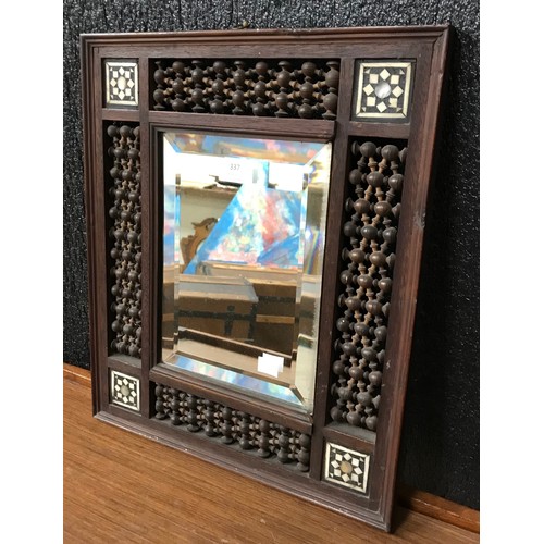 337 - An early 20th Century Moorish carved wood, mother of pearl and bone inlaid mirror