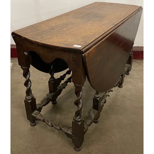 252 - A George II oak barleytwist gateleg dining table