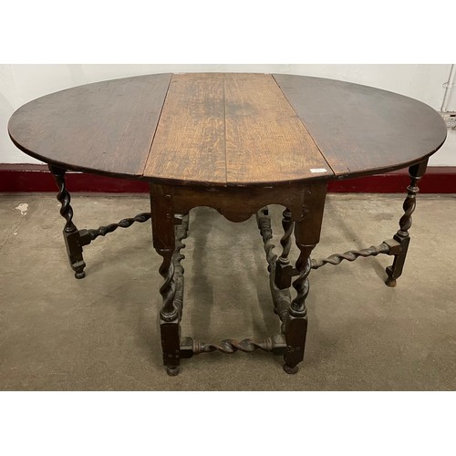 252 - A George II oak barleytwist gateleg dining table