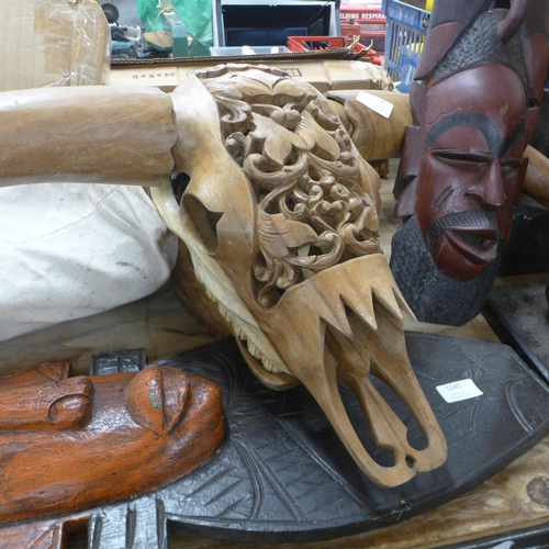 5245 - A quantity of carved wood and other decorative items including tribal masks, tribal wooden carved CD... 