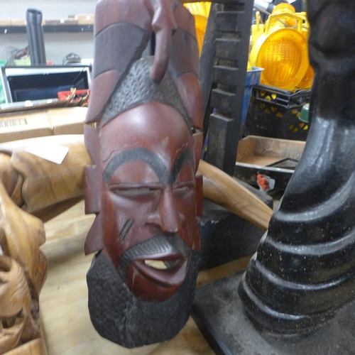 5245 - A quantity of carved wood and other decorative items including tribal masks, tribal wooden carved CD... 