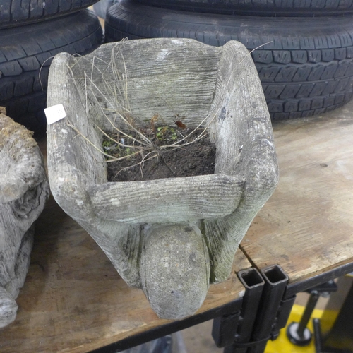 5251 - A concrete wheelbarrow planter and a concrete fox design planter