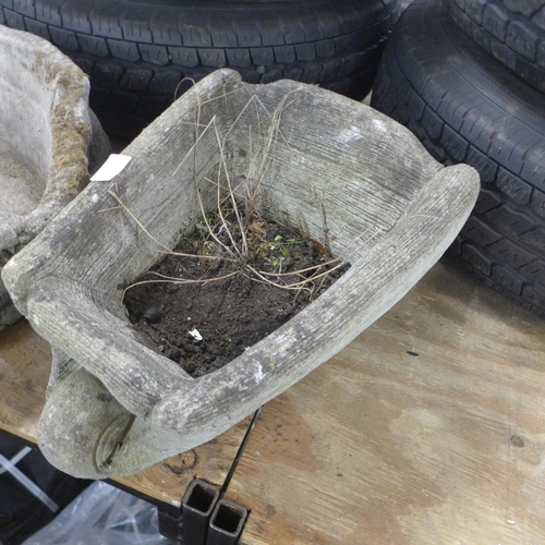 5251 - A concrete wheelbarrow planter and a concrete fox design planter