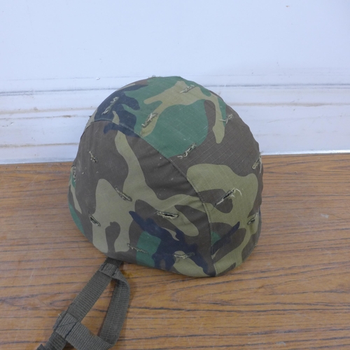 5255 - Two camouflaged combat helmets