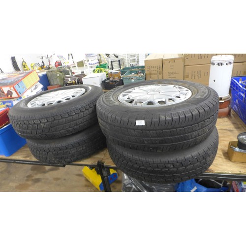 5266 - A set of four wheels and tyres including three Sumitomo 235/75R16C tyres and a Goodyear 215/75R16C t... 