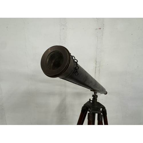 310 - An early 20th century brass telescope on tripod stand