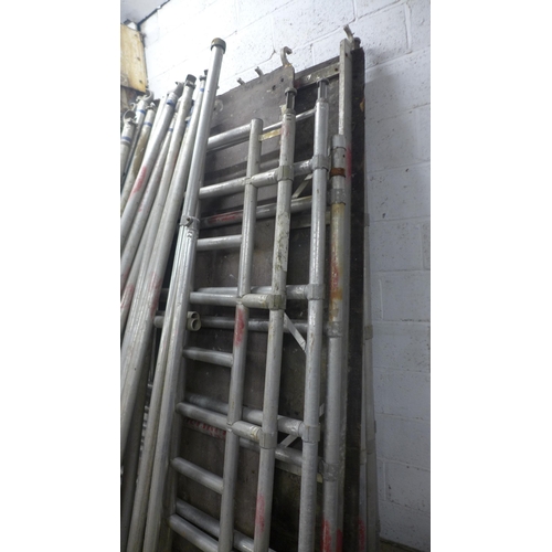 5144 - A large quantity of aluminium scaffolding with work platform, stabilisers, wheels and support beams