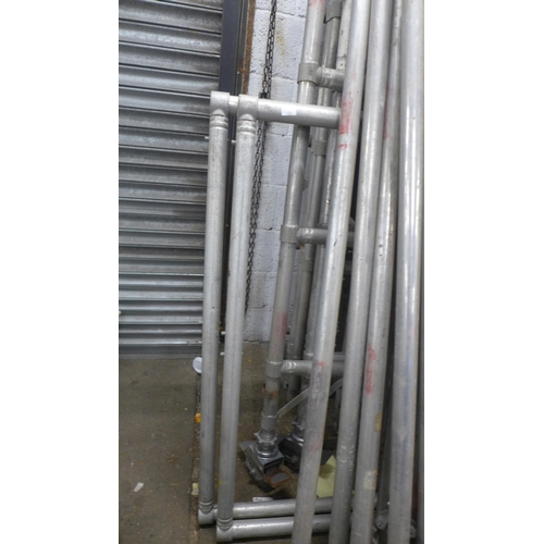 5144 - A large quantity of aluminium scaffolding with work platform, stabilisers, wheels and support beams