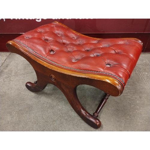 106A - A Regency style oxblood red leather footstool