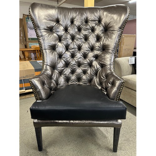 3249 - A leather wingback armchair