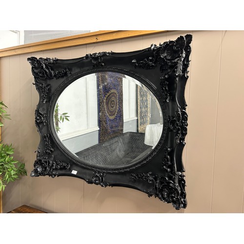 3026 - A black carved frame wall mirror