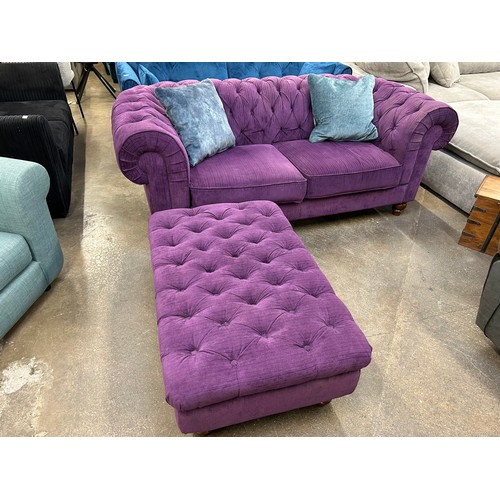 3149 - A violet upholstered button back three seater sofa and footstool (transit marked)