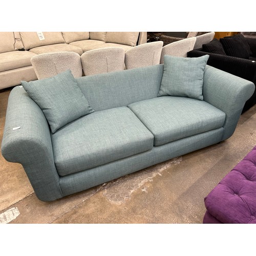 3168 - A turquoise upholstered three seater sofa (foot requires attention)