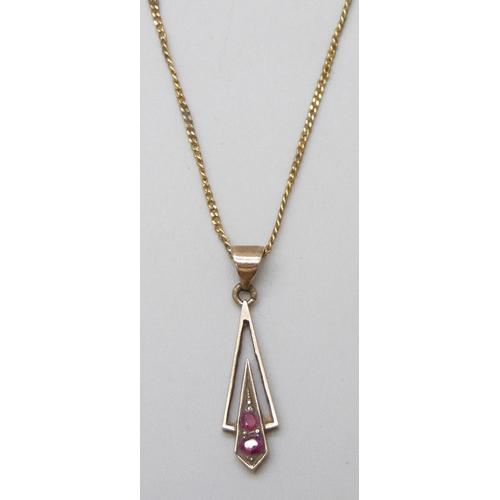 7005 - A fine 9ct gold chain, 1.2g, and a yellow metal and ruby pendant, 0.8g