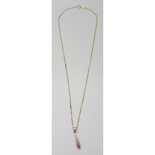 7005 - A fine 9ct gold chain, 1.2g, and a yellow metal and ruby pendant, 0.8g