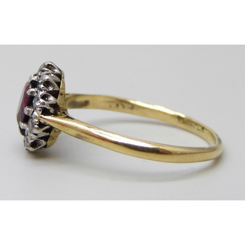 7019 - An 18ct gold and platinum set ruby and diamond cluster ring, 2.8g, M