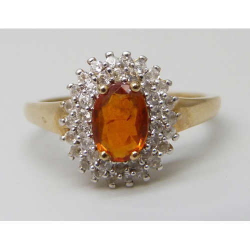 7023 - A 9ct gold, orange Kyanite and white zircon gold cluster ring with certificate, 2.27g, O