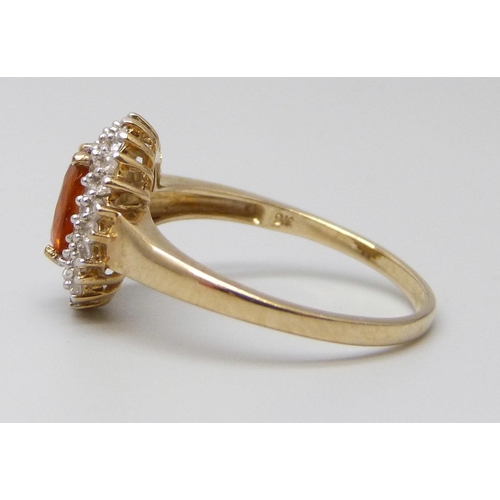 7023 - A 9ct gold, orange Kyanite and white zircon gold cluster ring with certificate, 2.27g, O