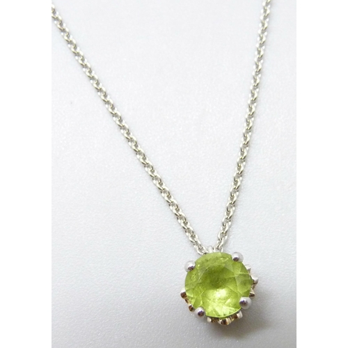 7031 - An 18ct white gold peridot pendant and chain with diamond set floral detail to setting, 3.6g, 6mm pe... 