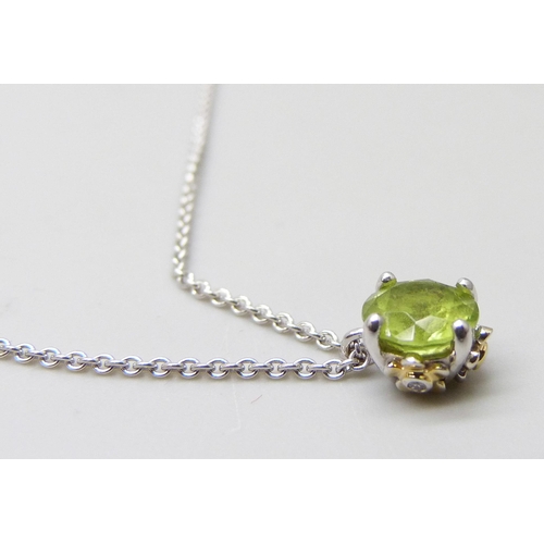 7031 - An 18ct white gold peridot pendant and chain with diamond set floral detail to setting, 3.6g, 6mm pe... 