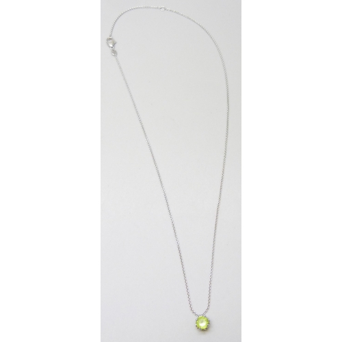 7031 - An 18ct white gold peridot pendant and chain with diamond set floral detail to setting, 3.6g, 6mm pe... 