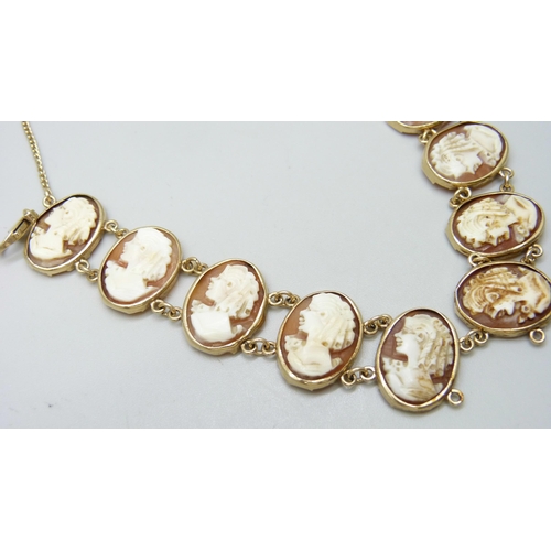 7040 - A 9ct gold mounted cameo panel bracelet, 14.7g total weight