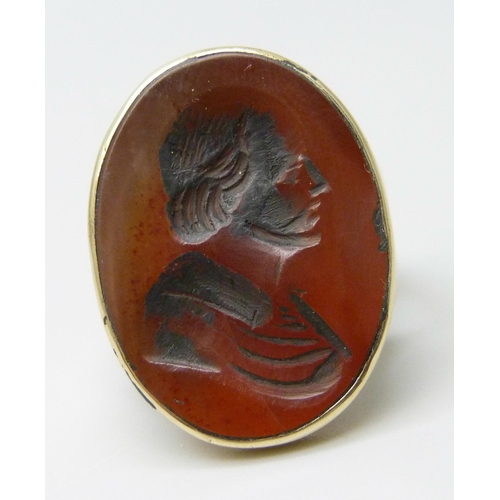 7041 - A yellow metal carnelian portrait intaglio seal ring, 6.3g, I, seal 2.3 x 1.9cm