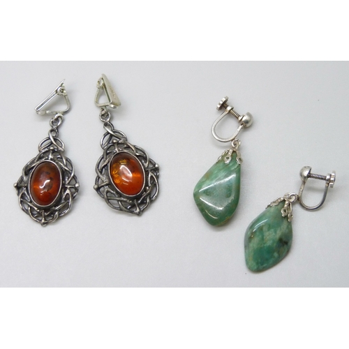 7043 - A pair of silver and amber earrings, and a green stone example on plated screw backs