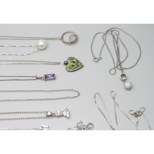 7046 - A collection of silver and white metal chains, pendants and a bracelet