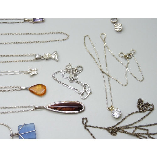 7046 - A collection of silver and white metal chains, pendants and a bracelet