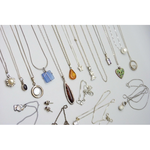 7046 - A collection of silver and white metal chains, pendants and a bracelet