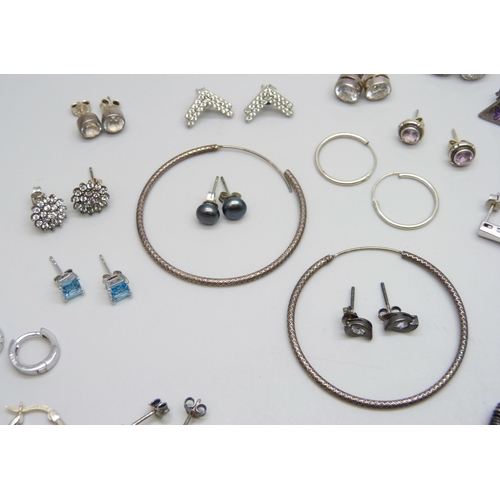 7061 - A collection of 25 pairs of silver and white metal earrings