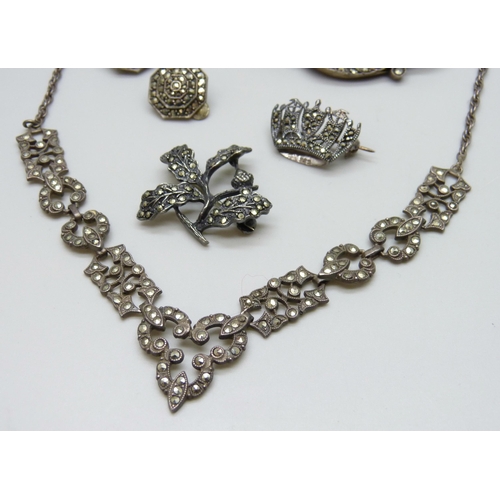 7063 - A silver necklace, two silver rings, two silver brooches, 33g, together with two pairs of plated ear... 