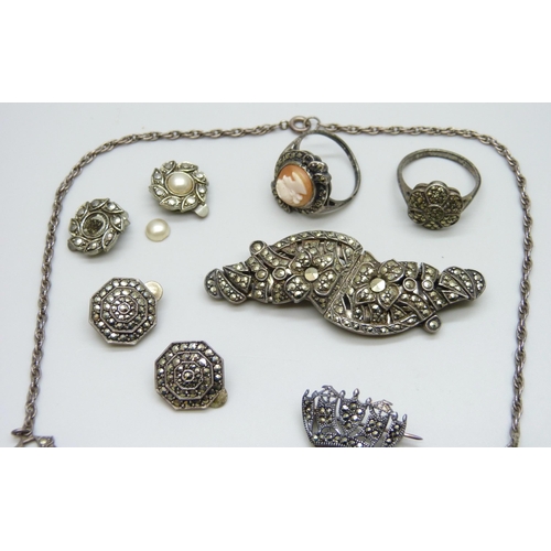 7063 - A silver necklace, two silver rings, two silver brooches, 33g, together with two pairs of plated ear... 