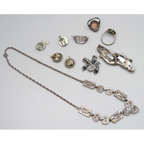 7063 - A silver necklace, two silver rings, two silver brooches, 33g, together with two pairs of plated ear... 