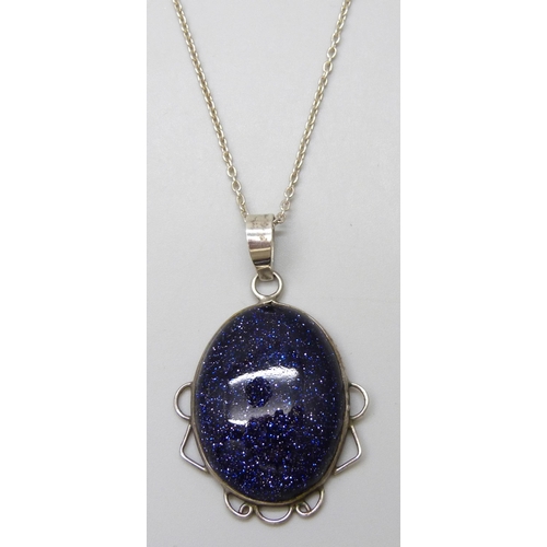 7076 - A silver mounted purple goldstone pendant on chain, 17g