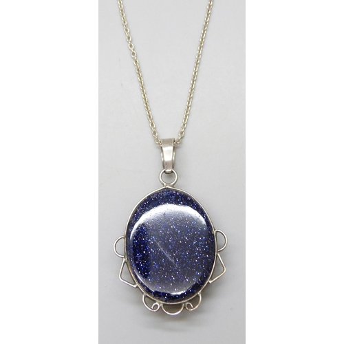 7076 - A silver mounted purple goldstone pendant on chain, 17g