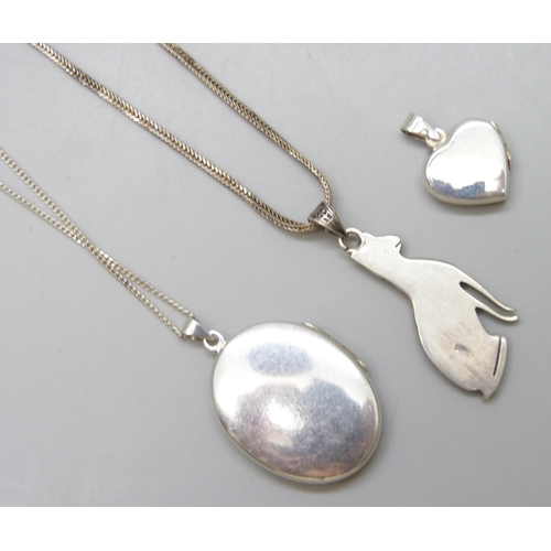 7077 - Two silver lockets and chains and a silver cat pendant, 28g