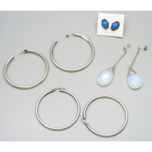 7078 - Three pairs of silver earrings, and a pair of large white metal hoop earrings