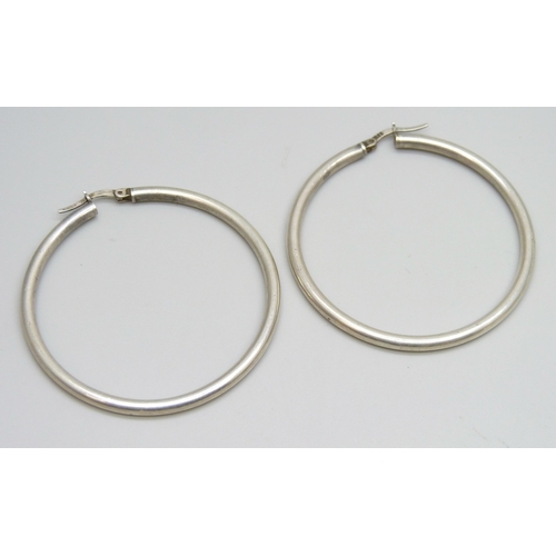 7078 - Three pairs of silver earrings, and a pair of large white metal hoop earrings