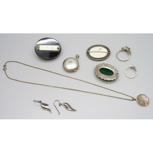 7084 - A collection of silver jewellery including a locket and ring, together with a carved jet brooch, (je... 