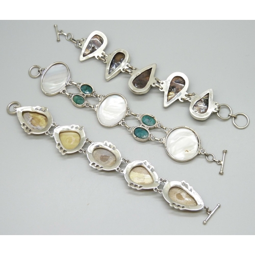 7101 - Three silver bracelets set with mother of pearl, 128g