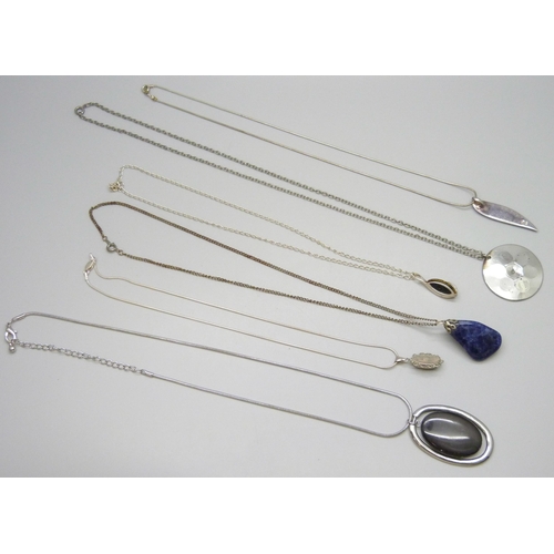 7105 - Three silver pendants and chains including a Malcolm Gray enamel example, 19g total, together with p... 