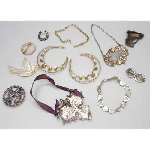 7107 - Two silver brooches, a white metal brooch, a silver bracelet, together with badges, spirit labels, W... 