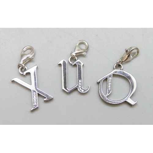 7110 - A collection of three silver Thomas Sabo charms, as new, together with a pair of other silver earrin... 