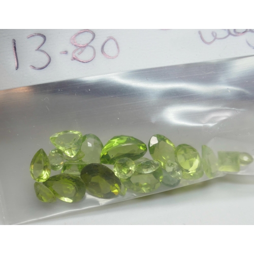 7143 - Gemstones - A collection of peridot, 13.8ct total, and garnet, 41.7ct total, and a magnetic display ... 