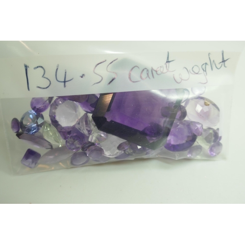 7144 - Gemstones - A collection of topaz, 93.85ct total, and amethyst, 134.55ct total