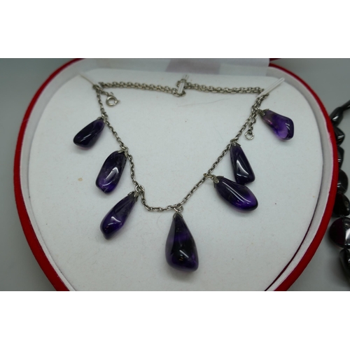 7170 - An amethyst drop necklace and an amethyst necklace with a silver clasp