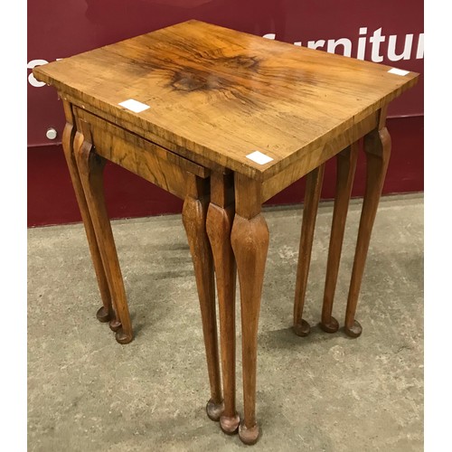 129 - A Queen Anne style figured walnut nest of tables